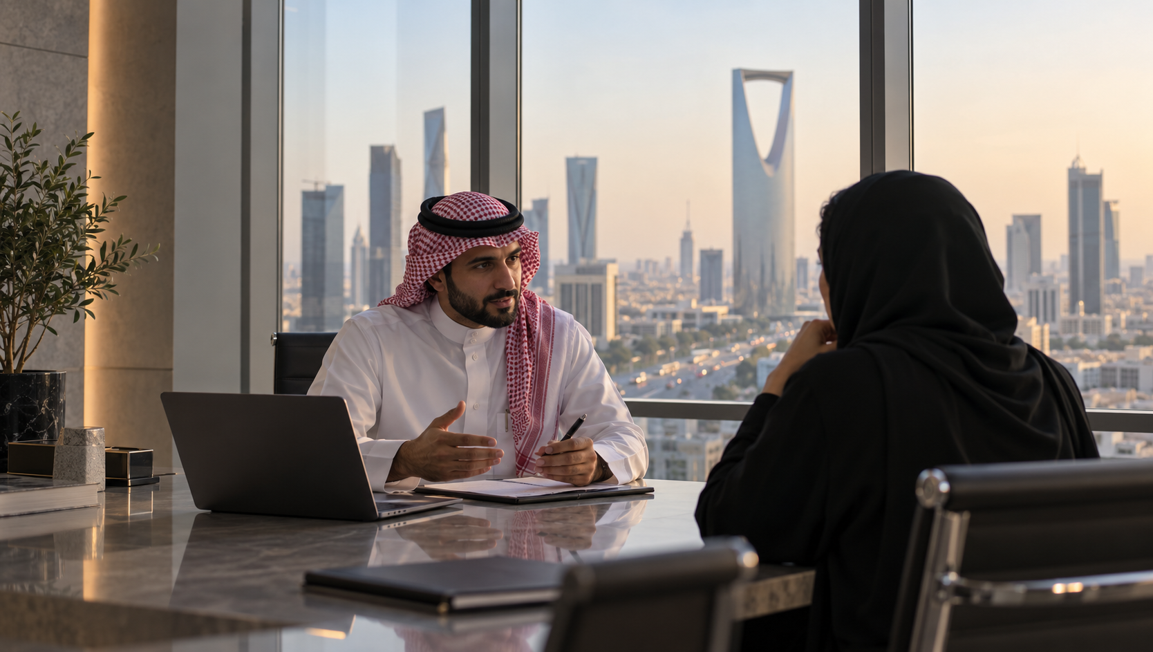 Saudi financial professionals discussing advisory services in a Riyadh office